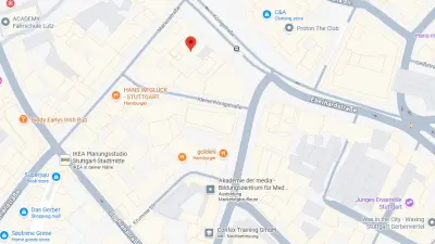  A digital street map of Stuttgart-Mitte, Germany, marking the location of a business or office with a red pin. The map displays surrounding streets such as Königstraße, Marienstraße, and Kronprinzstraße, as well as notable landmarks including Segmüller, IKEA Planungsstudio, HANS IM GLÜCK, and Akademie der media. This serves for visual location identification and directions for visitors or customers of the marked address.