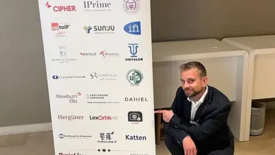 Photo of project leader with the sponsor banner which shows Origify